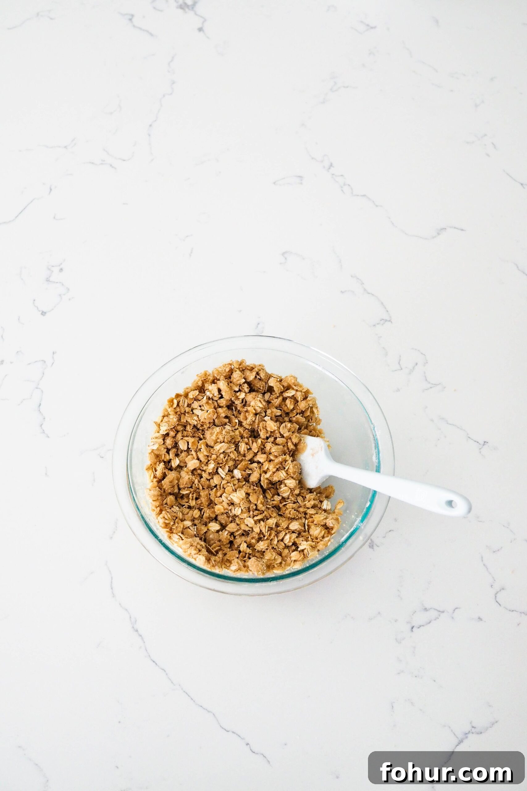 Cherry Crumble Bars with Buttery Oat Crust 6 A bowl of oat crumble with a spatula sticking out.