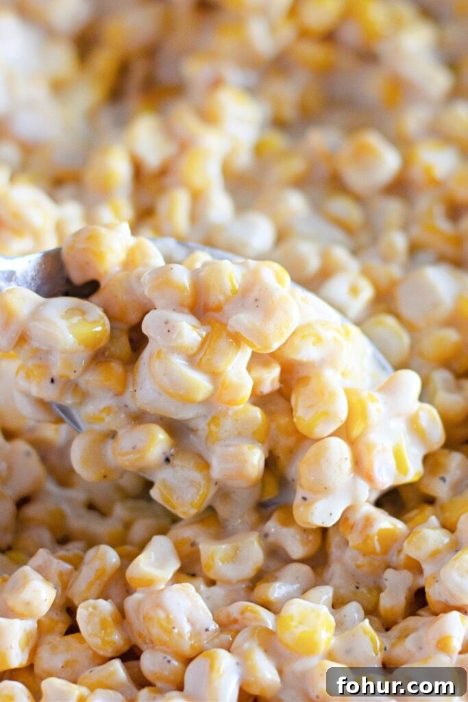creamed corn with a spoonful above the bowl
