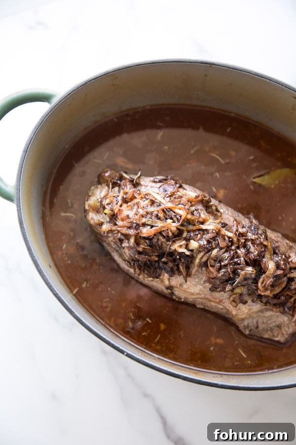 Passover Brisket Recipe for Any Jewish Holiday Dinner 5 jewish brisket topped with caramelized onions in a dutch oven before going back in the oven