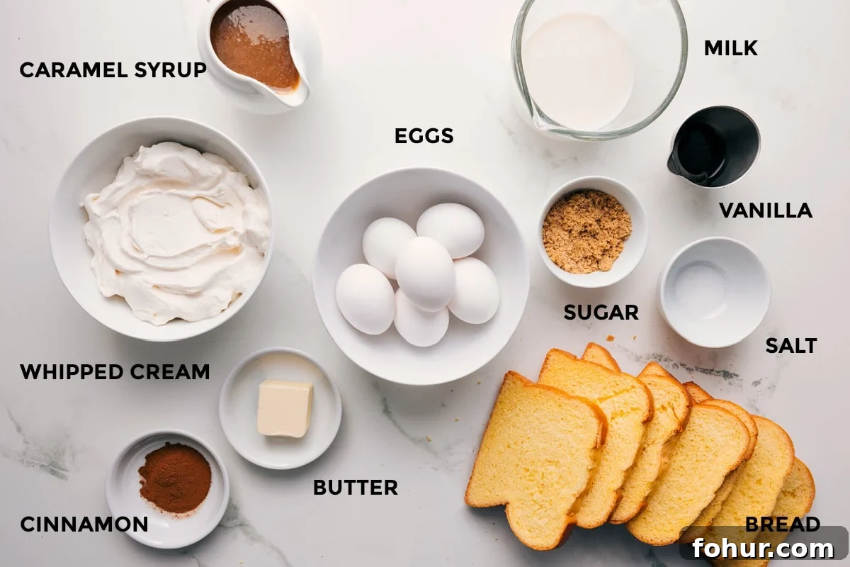 All the ingredients in this recipe prepped out for easy assembly including the whipped cream, cinnamon, butter, bread, eggs, sugar, salt, vanilla, milk, and syrup.