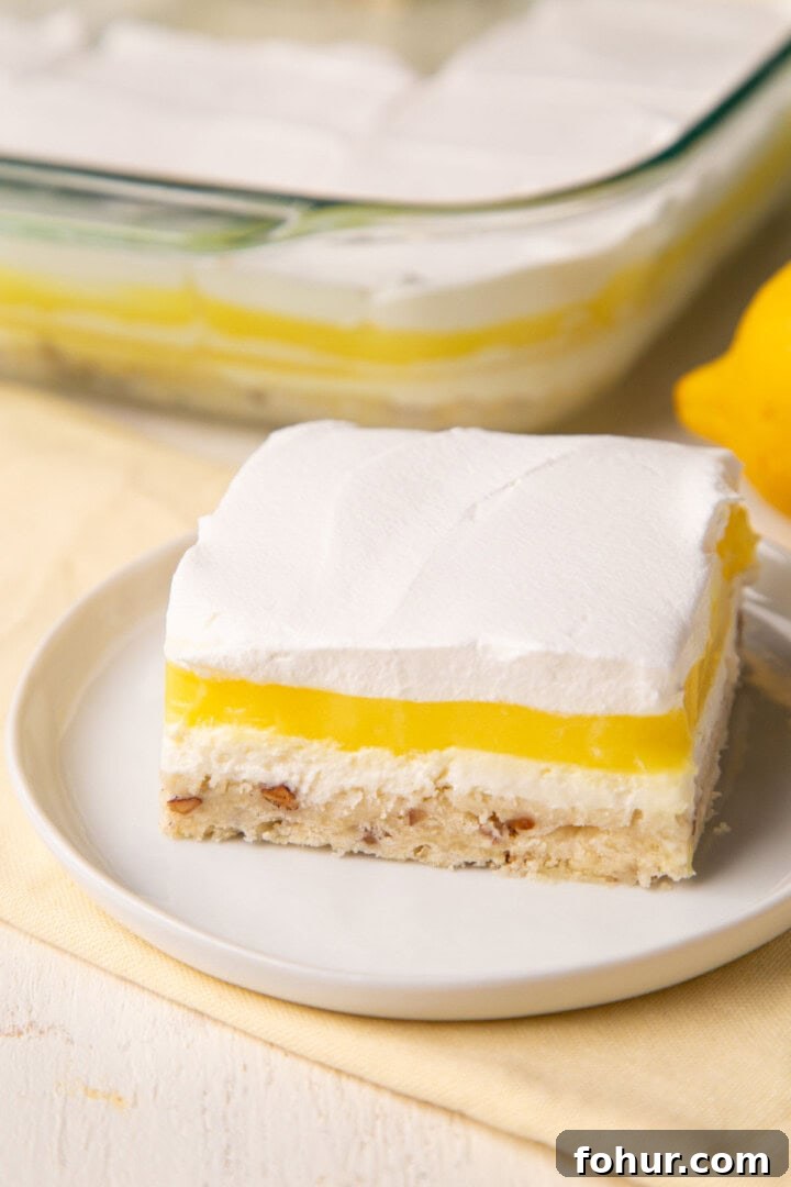 layered lemon pudding dessert on a white plate.