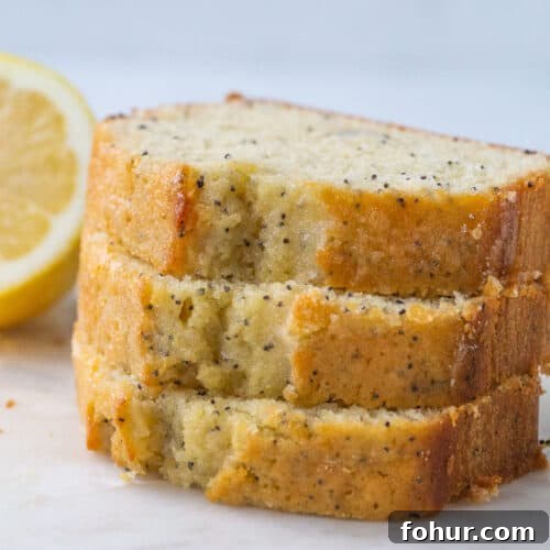 three slices of lemon poppy seed bread stacked up.