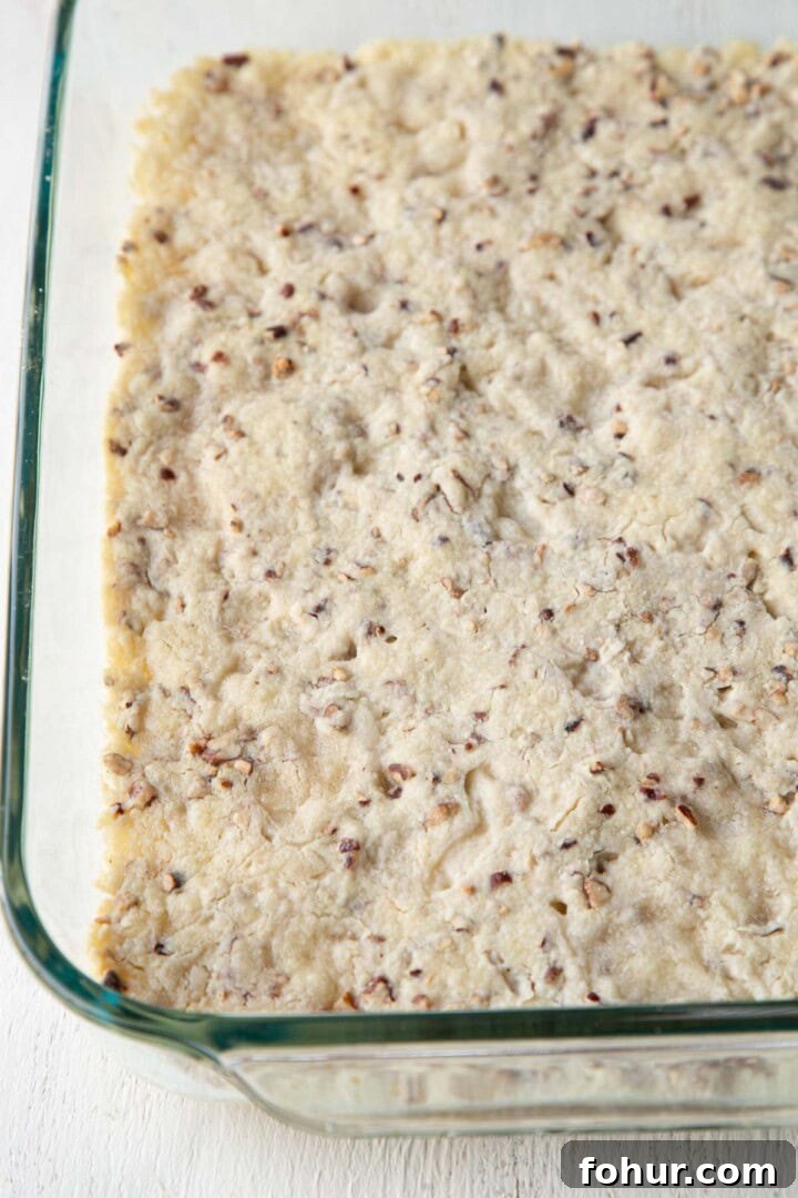 cooked pecan crust in a baking dish.