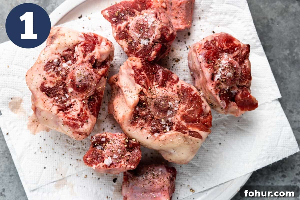 Slow-Braised Oxtail Recipe with Red Wine and Herbs 4 Oxtails on a paper towel sprinkled with salt and pepper.