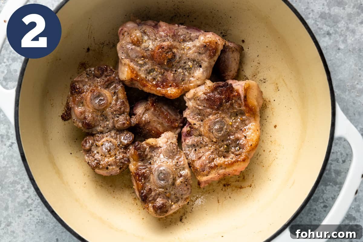 Slow-Braised Oxtail Recipe with Red Wine and Herbs 5 Seared oxtails in a dutch oven.