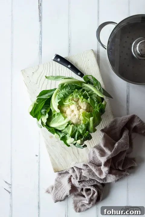 How to Cook Cauliflower: Roast, Steam, Saute and More 2 A whole cauliflower on a chopping board with a knife