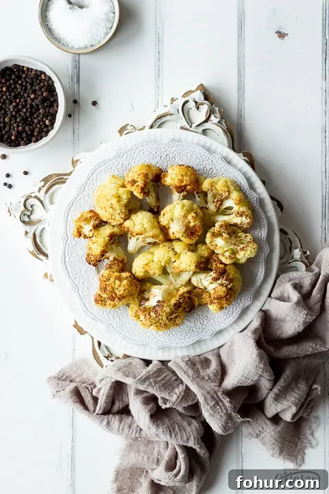 How to Cook Cauliflower: Roast, Steam, Saute and More 4 Close up of roast cauliflower on a white plate