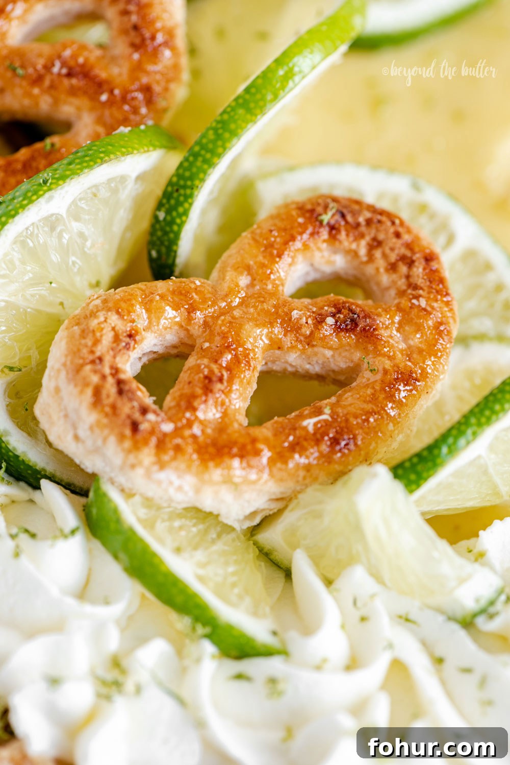 Classic Key Lime Pie Recipe with Graham Cracker Crust 2 Easy Key Lime Pie decorated with homemade whipped cream, puff pastry twists, and sliced limes | Image and Copyright Policy: © Beyond the Butter, LLC