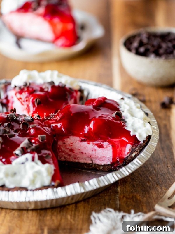 Classic Key Lime Pie Recipe with Graham Cracker Crust 4 Sliced no bake strawberry chocolate cream pie on wood table with a fork and small bowl of chocolate curls nearby.