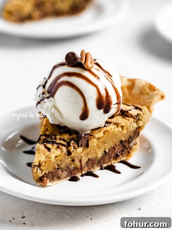 Classic Key Lime Pie Recipe with Graham Cracker Crust 6 Angled closeup image of Chocolate Chip Pie with a scoop of vanilla ice cream on top that's drizzled with chocolate syrup.
