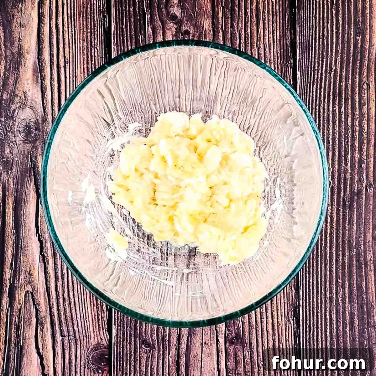 How to Make Fluffy Banana Pancakes 5 Mashed banana in a bowl.