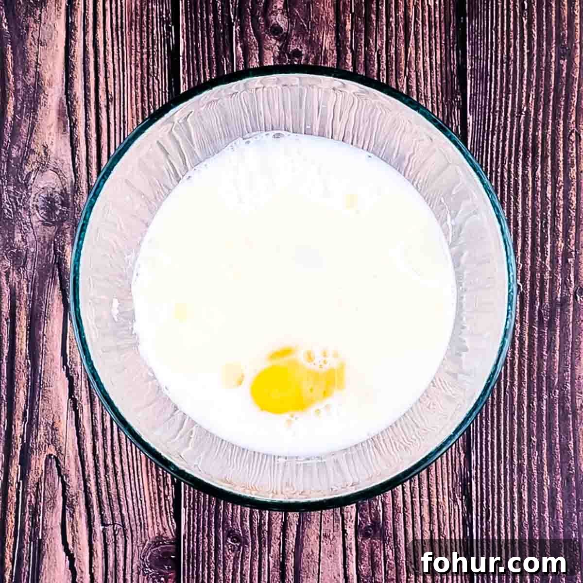 How to Make Fluffy Banana Pancakes 6 Wet ingredients for the pancakes in a large bowl.