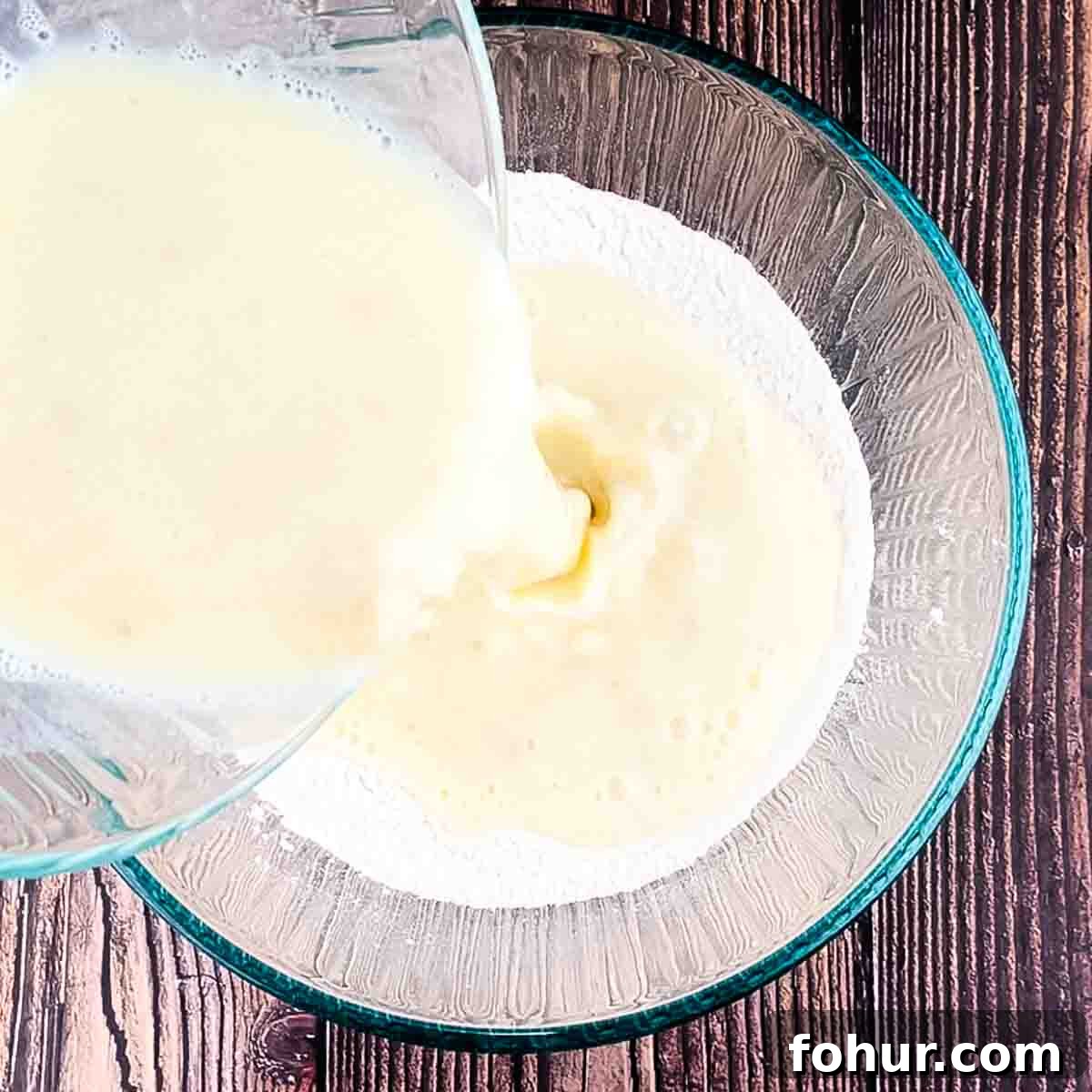 How to Make Fluffy Banana Pancakes 7 The wet ingredients being added to the dry ingredients.