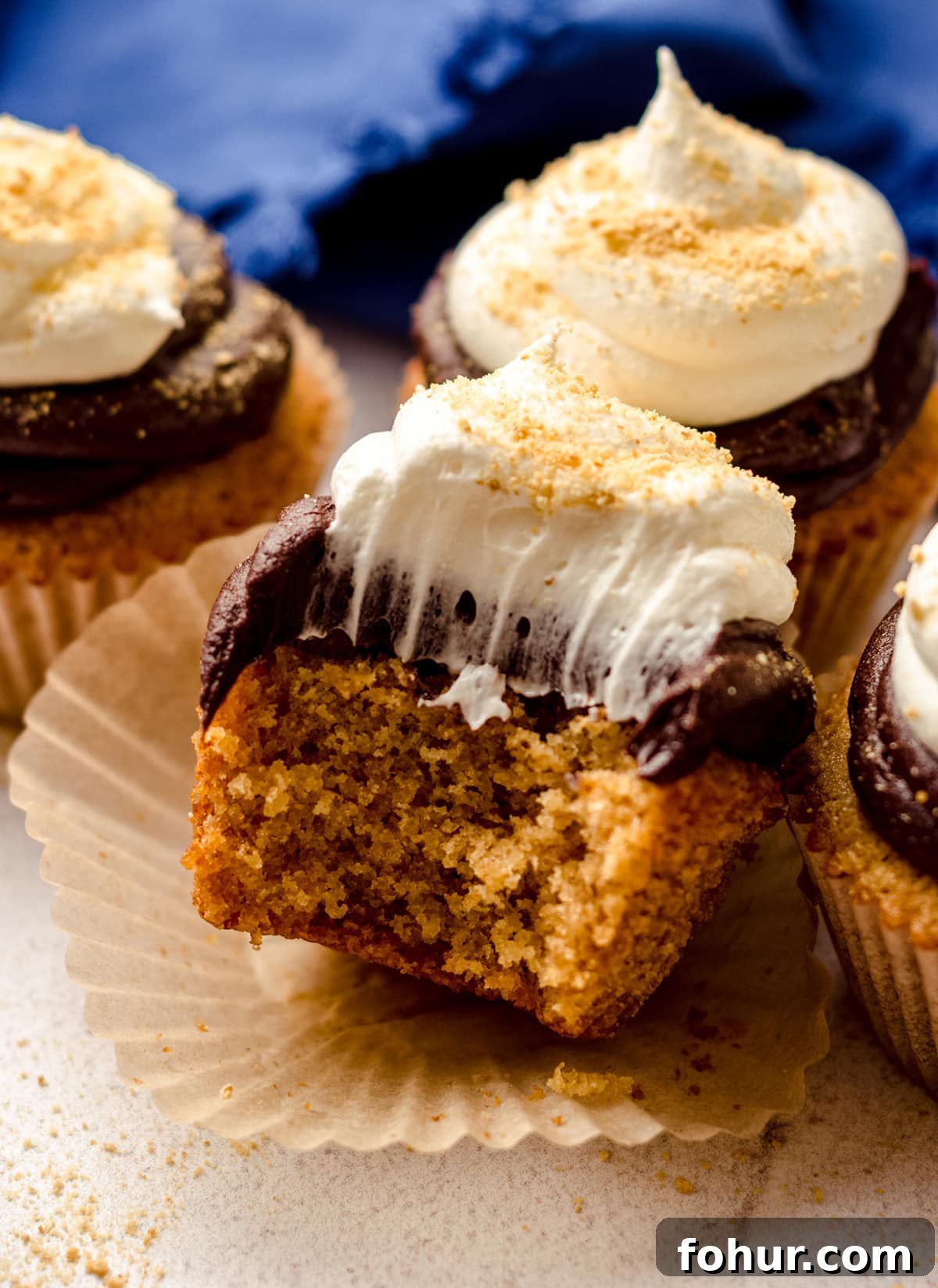 Decadent S'mores Cupcakes with Toasted Marshmallow Frosting 11 s'mores cupcake with a bite taken out of it