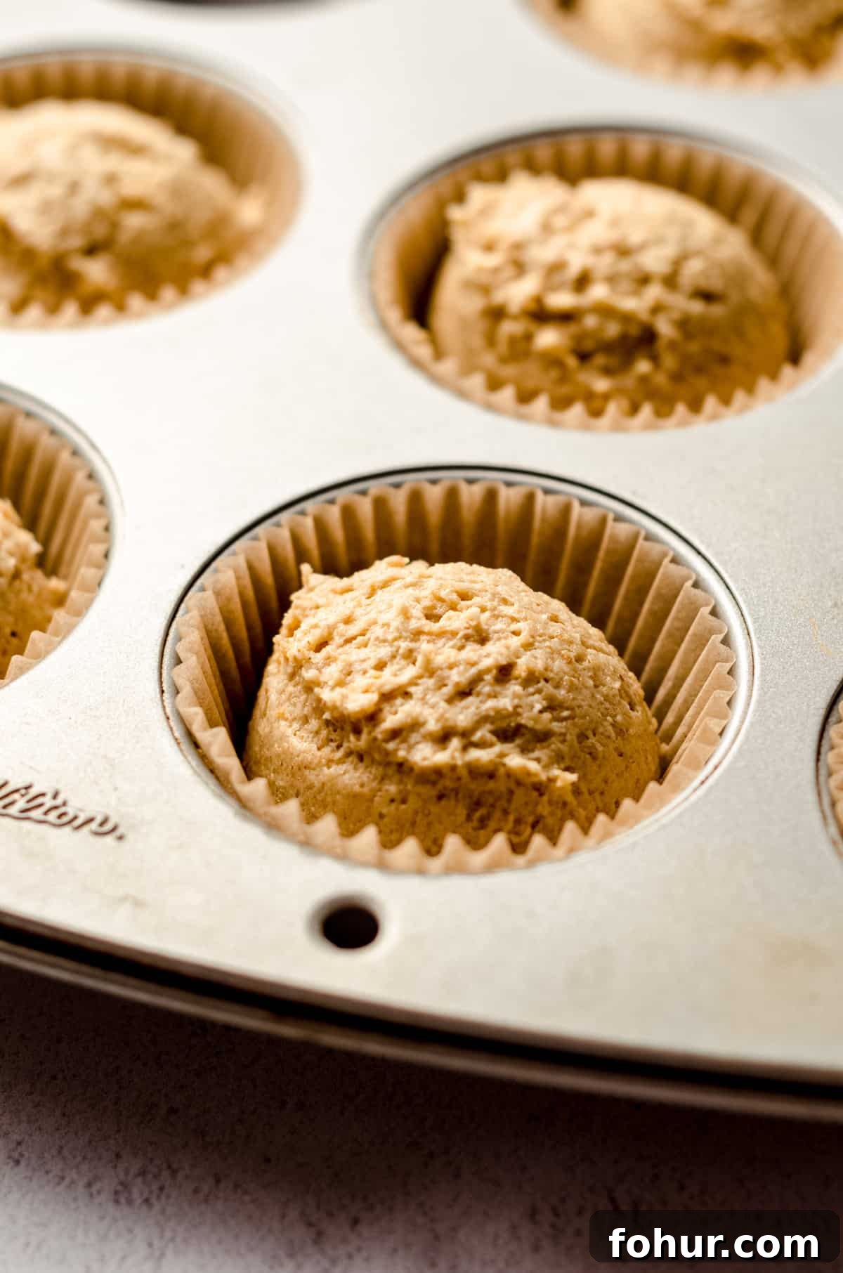 Decadent S'mores Cupcakes with Toasted Marshmallow Frosting 3 graham cracker cupcake batter in a cupcake pan