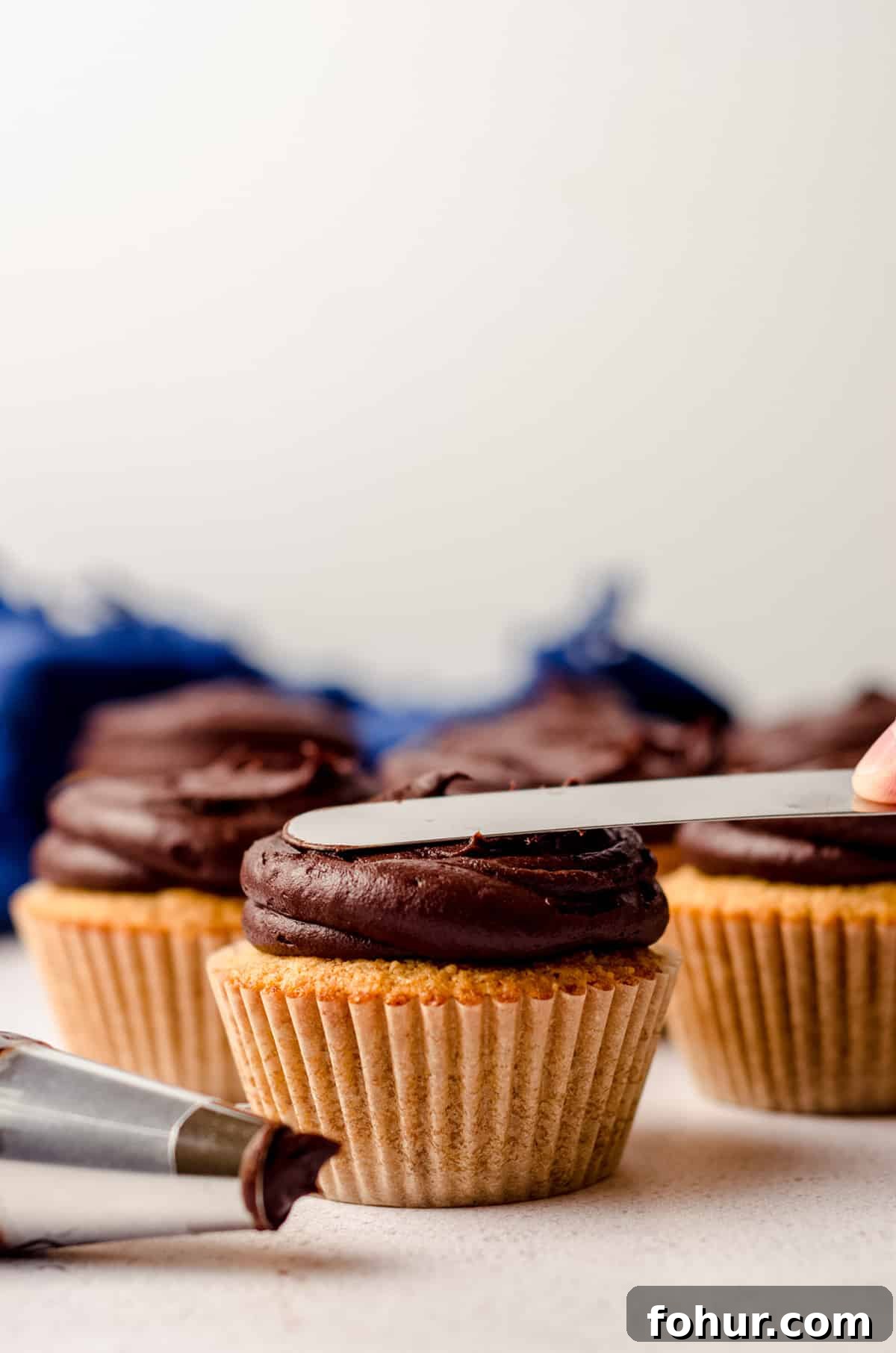 Decadent S'mores Cupcakes with Toasted Marshmallow Frosting 7 flattening chocolate buttercream on a s'mores cupcake