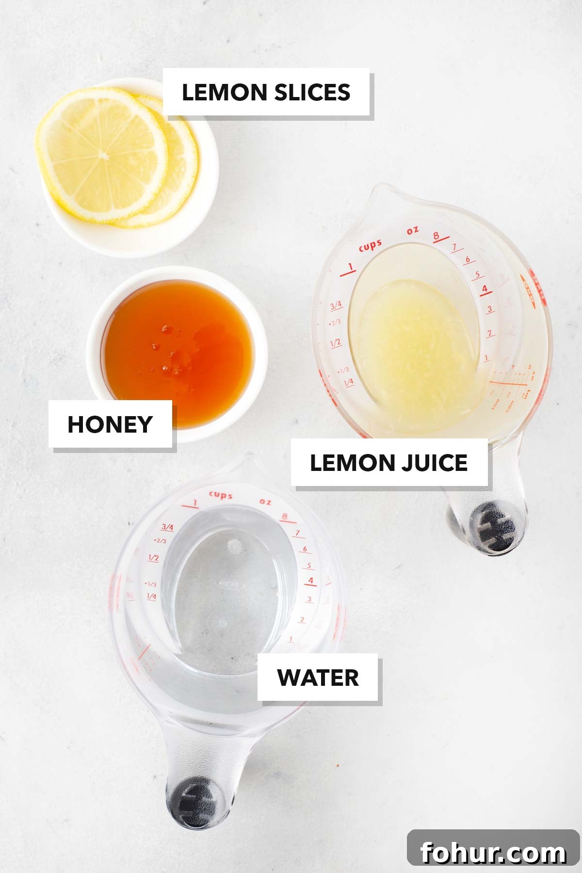 How to Make Homemade Lemon Tea: Fresh Citrus Recipe 3 Lemon Tea ingredients measured in cups and labeled on a table.