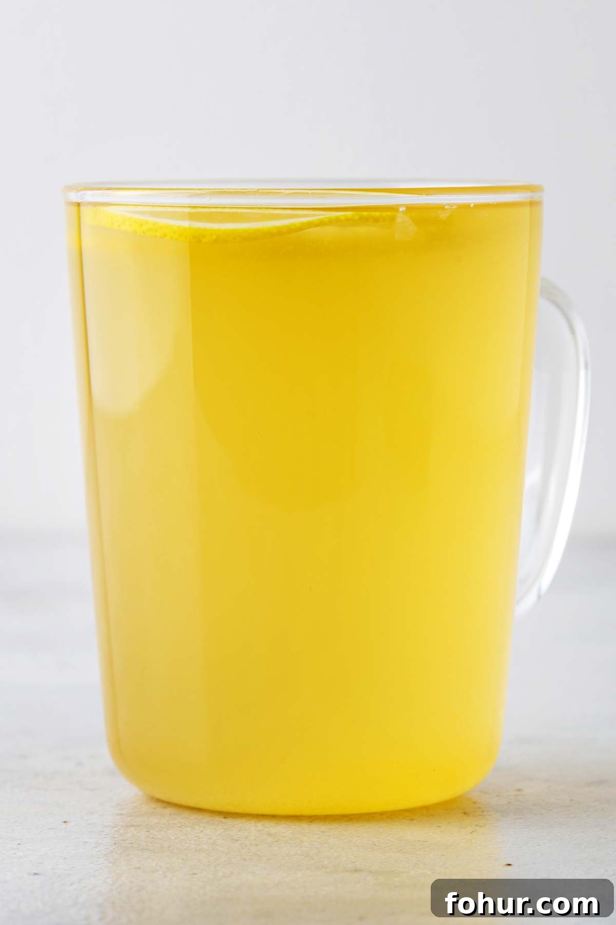 How to Make Homemade Lemon Tea: Fresh Citrus Recipe 6 Lemon tea in a glass mug.