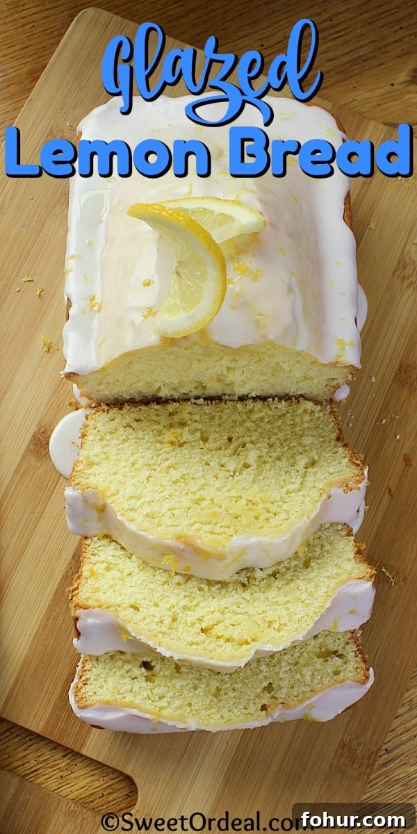 A loaf of partially sliced lemon bread.