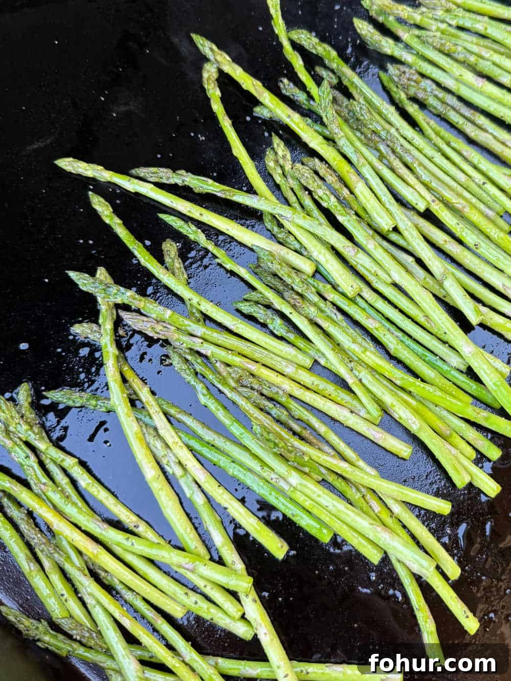 Blackstone Griddle Asparagus Recipe: Quick Grilled Asparagus 7 cooked asparagus on griddle.