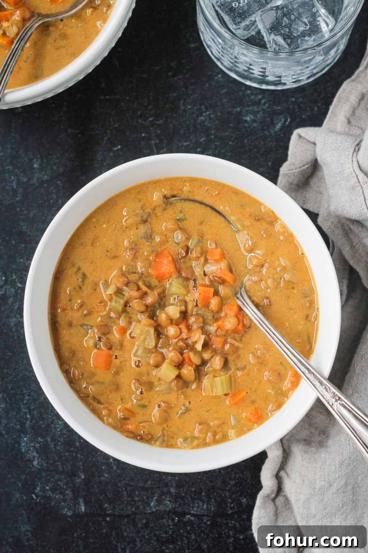 Curried Carrot and Lentil Soup Recipe 2 Overhead view of a bowl of curried carrot lentil soup.