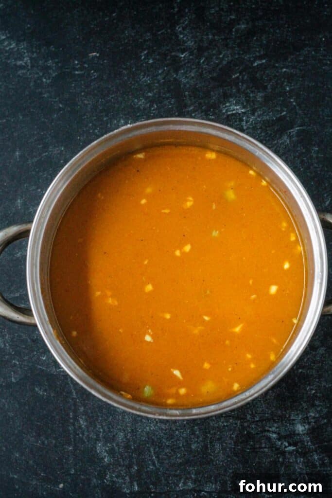 Curried Carrot and Lentil Soup Recipe 7 Broth added to the vegetables in the pot.