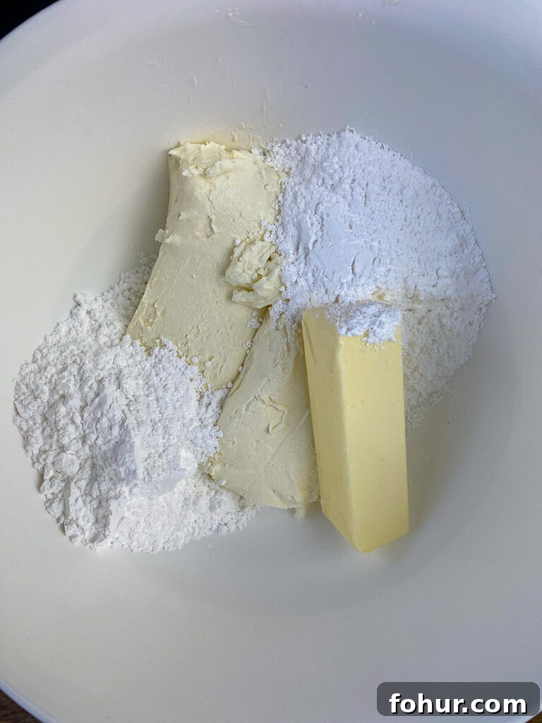 Dirt Cake Recipe to Feed a Crowd 5 Softened butter and cream cheese with powdered sugar in a large white mixing bowl