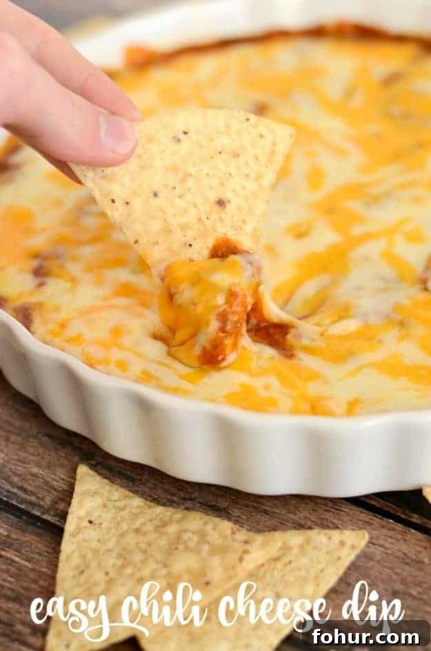 Chili Cheese Dip - loaded with beans, cream cheese, and two kinds of cheeses, this dip is always a hit! chili cheese dip in a white serving dish