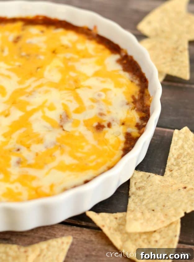 Easy Chili Cheese Dip - this hot and cheesy dip is always devoured. chili cheese dip with tortilla chips