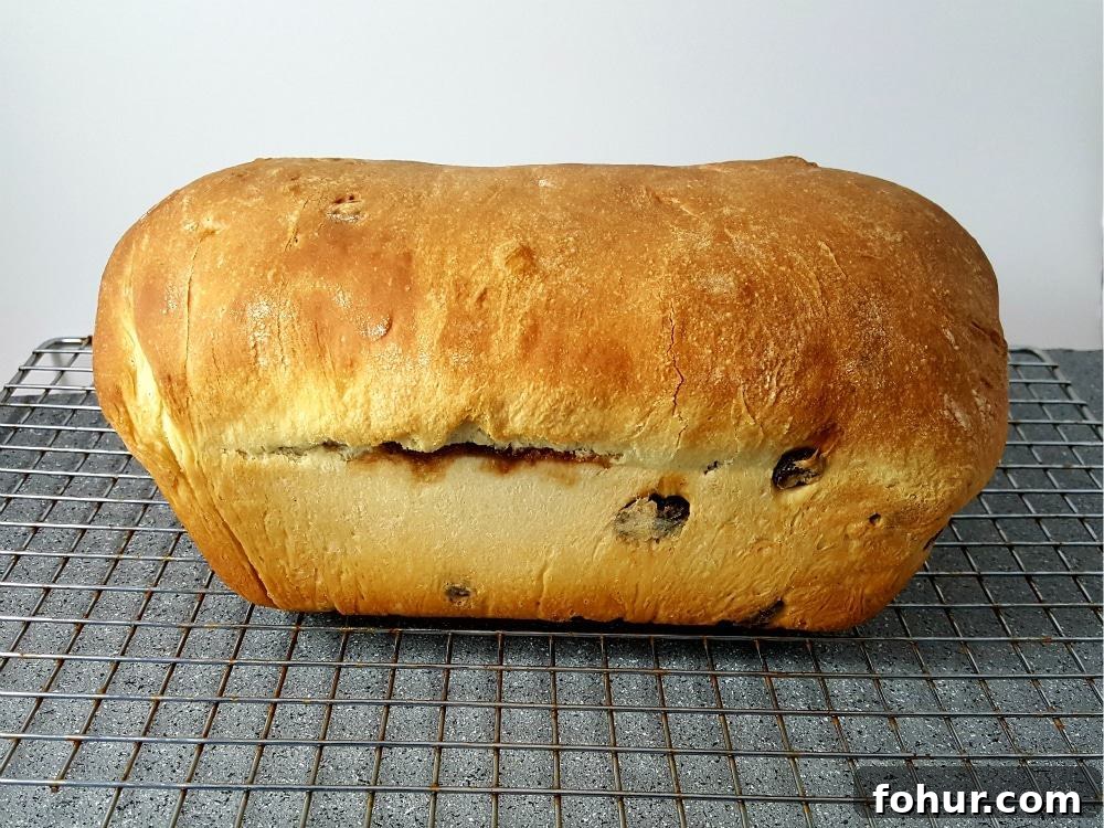 Cinnamon Swirl Raisin Bread Recipe: Homemade Loaf 8 a baked loaf Easy Cinnamon Swirl Bread on a wire rack.