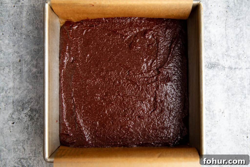 Fudgy Pumpkin Cheesecake Swirl Brownies Recipe 6 brownie batter spread into the bottom of a parchment lined square brownie pan