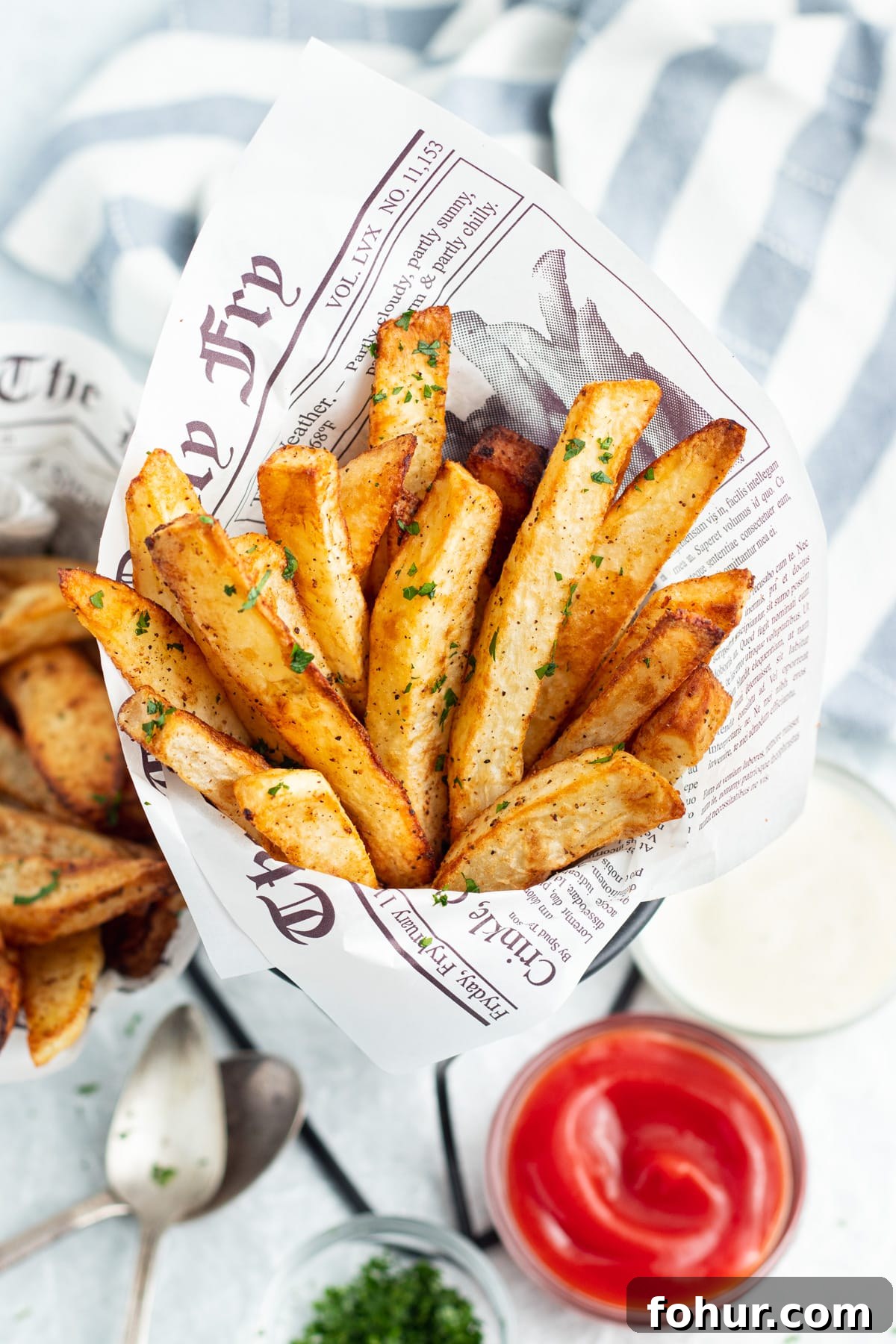 Crispy Air Fryer Steak Fries Recipe 5 Picture of steak fries with a side of ranch, and ketchup.