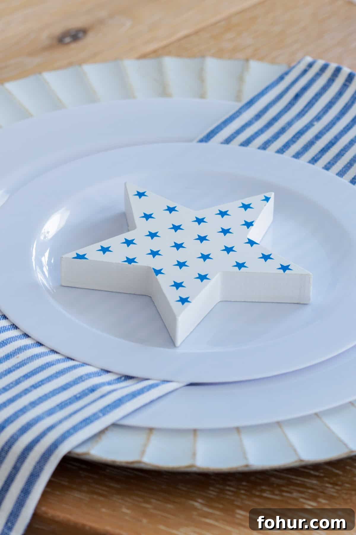 4th of July Tablescape Ideas for Festive Patriotic Decor 11 Place setting with white star printed with blue stars.