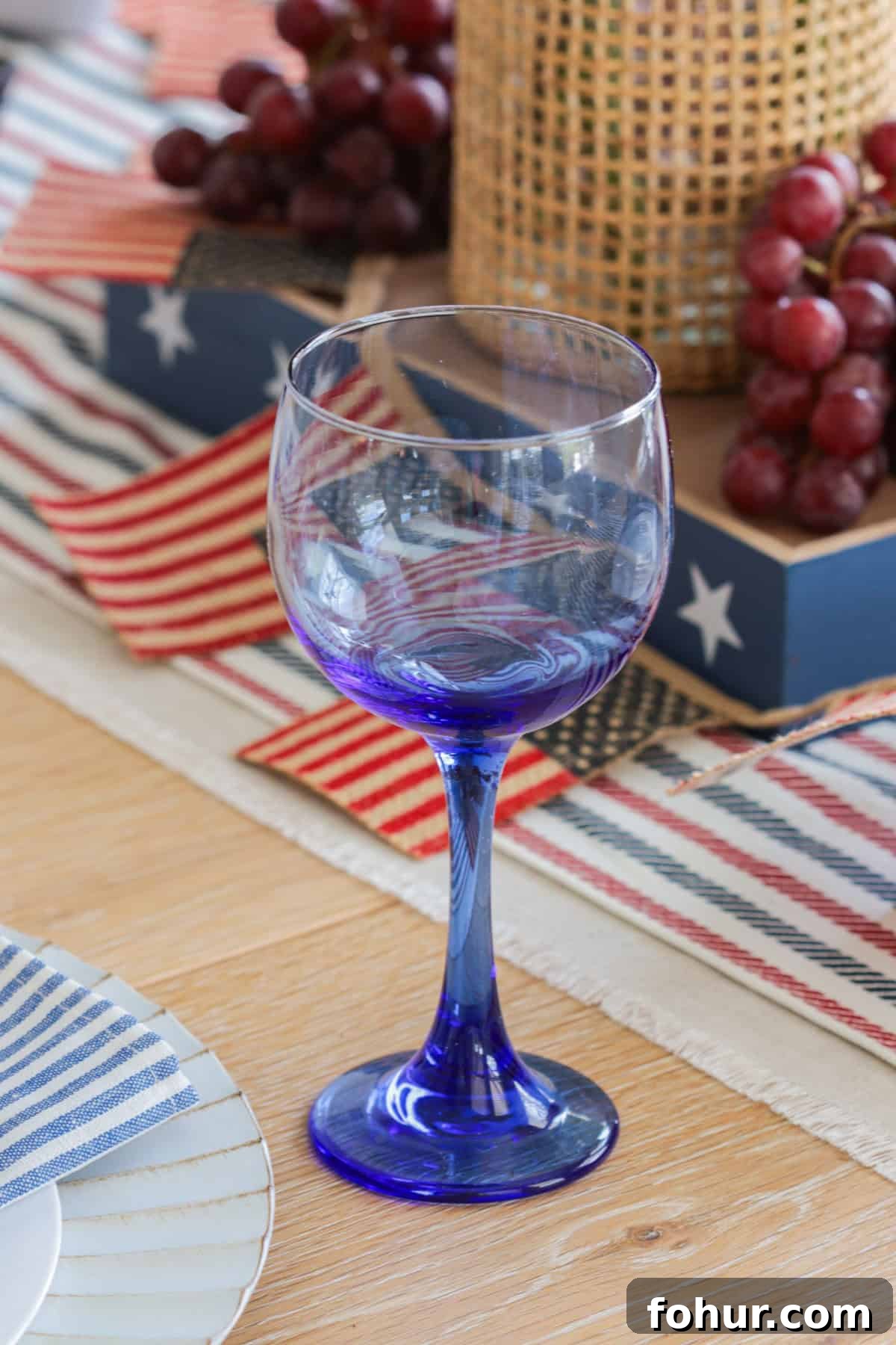 4th of July Tablescape Ideas for Festive Patriotic Decor 15 Blue wine glass on table.