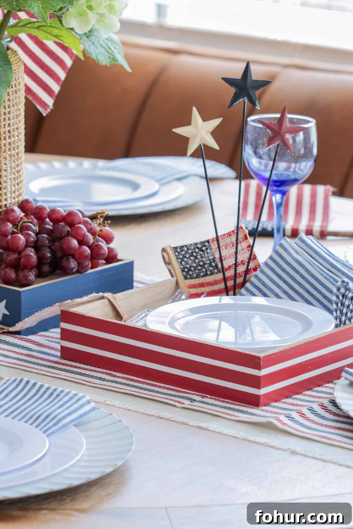 4th of July Tablescape Ideas for Festive Patriotic Decor 17 Red white and blue decor with red box holding plates and napkins.