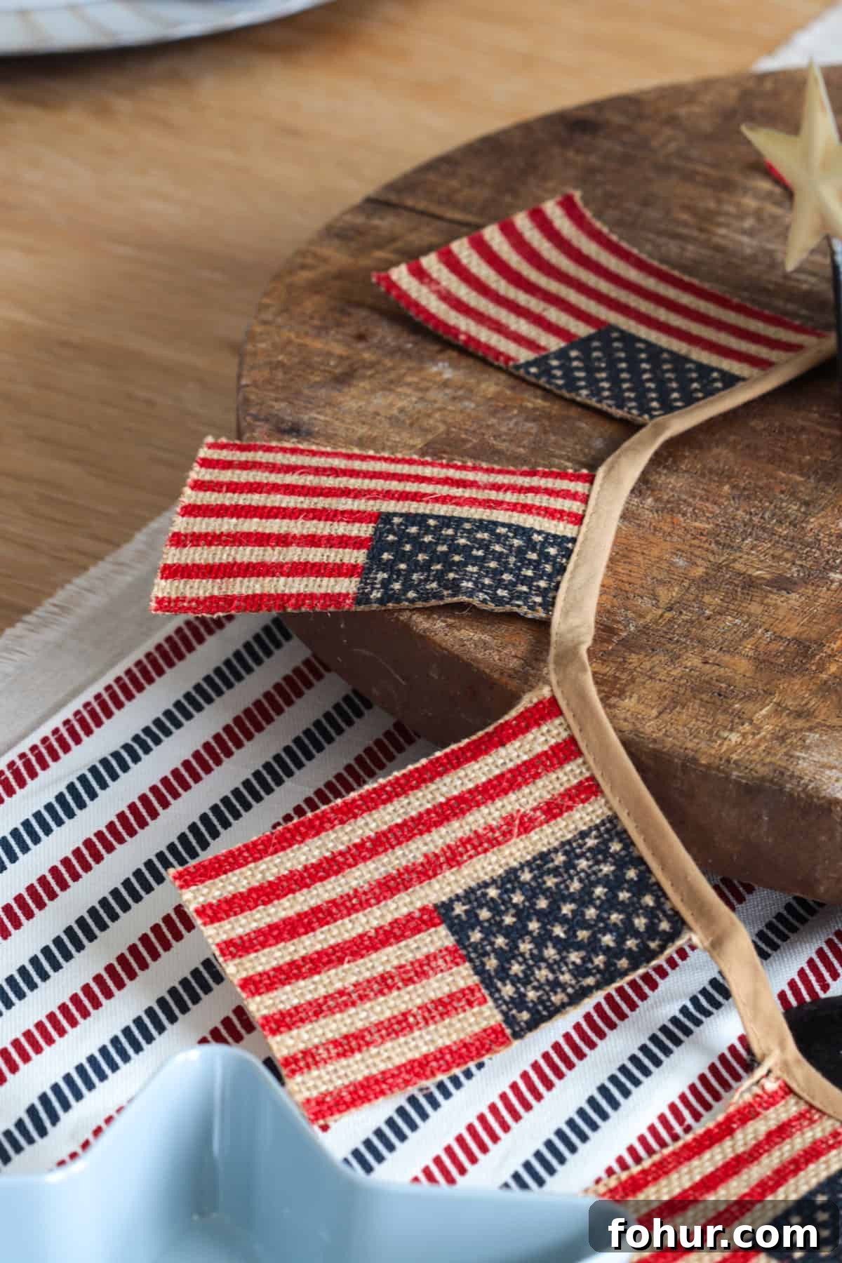 4th of July Tablescape Ideas for Festive Patriotic Decor 3 American flag banner draped over table.