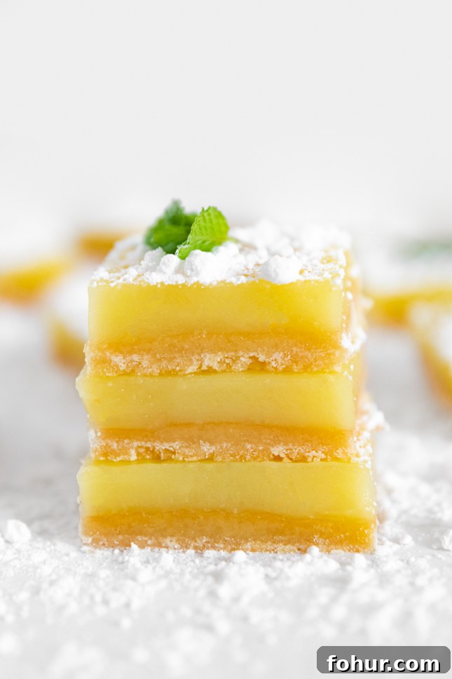 Tangy Vegan Lemon Bars Recipe with Shortbread Crust 4 Photo of a pile of vegan lemon bars
