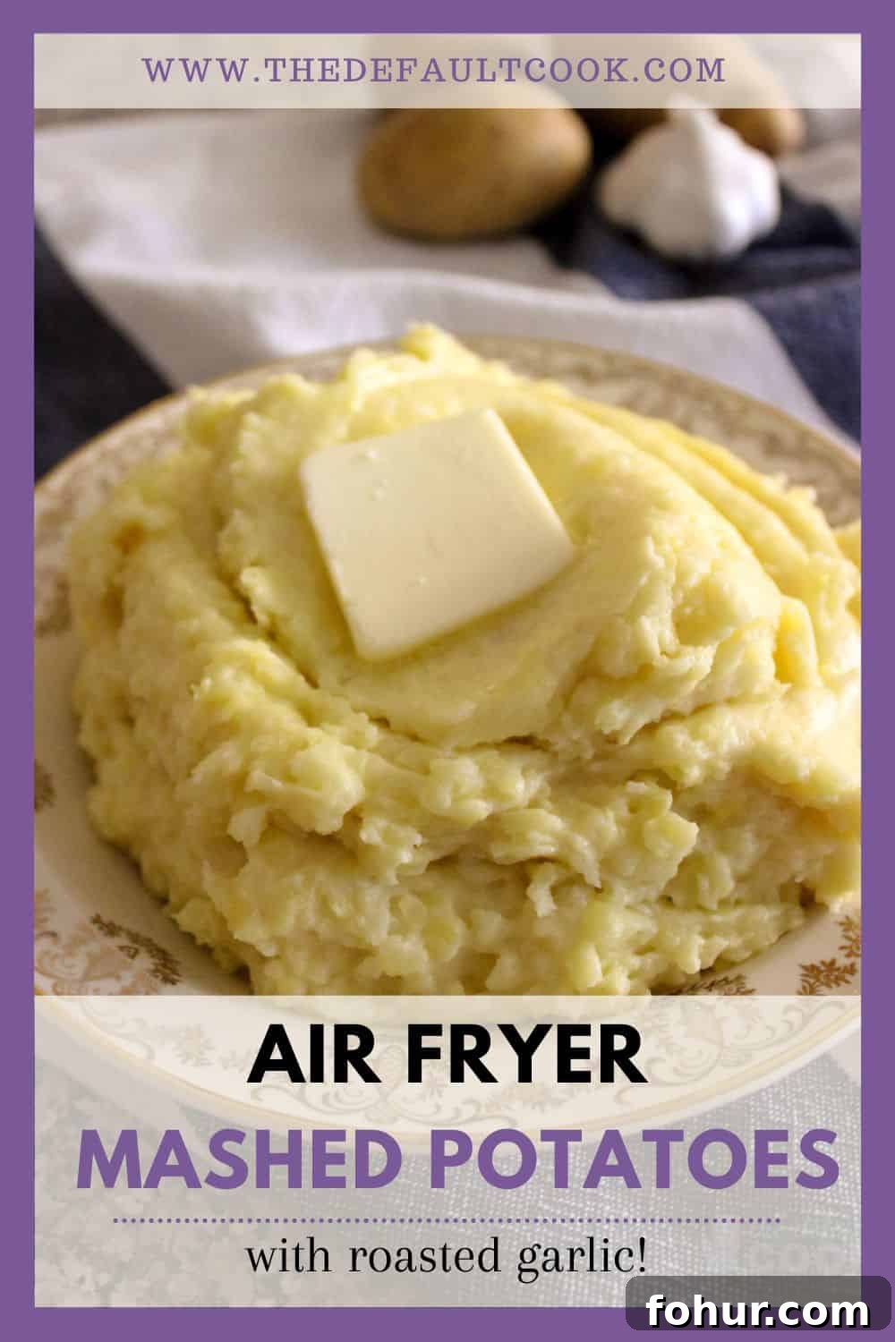 Creamy Garlic Mashed Potatoes Made in an Air Fryer 9 Mashed potatoes on a plate with butter melting on them, and uncooked potatoes and garlic in the background.