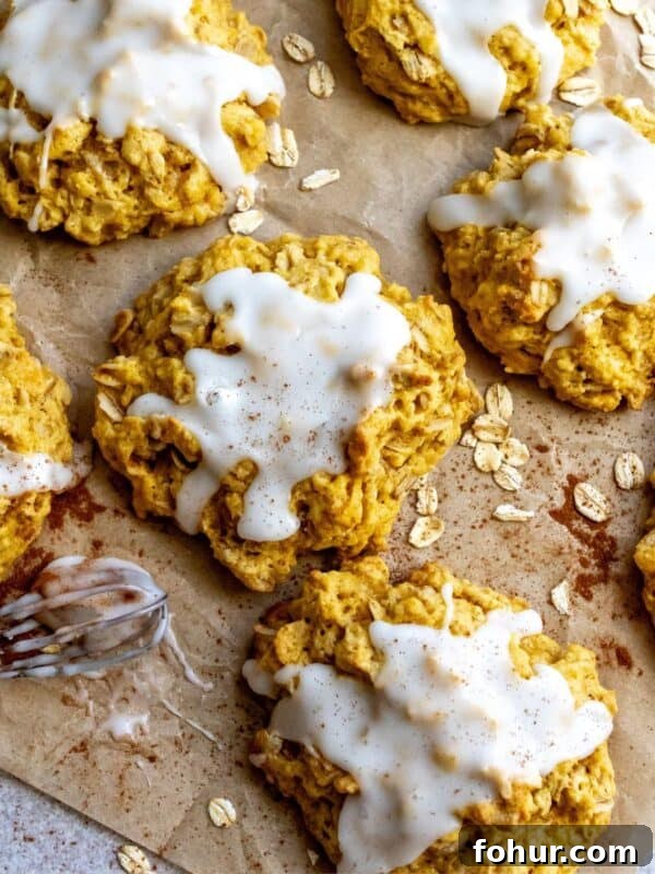 3-Ingredient Pumpkin Muffins Recipe 9 Pumpkin Pie Cookies on parchment paper with oats on the side.