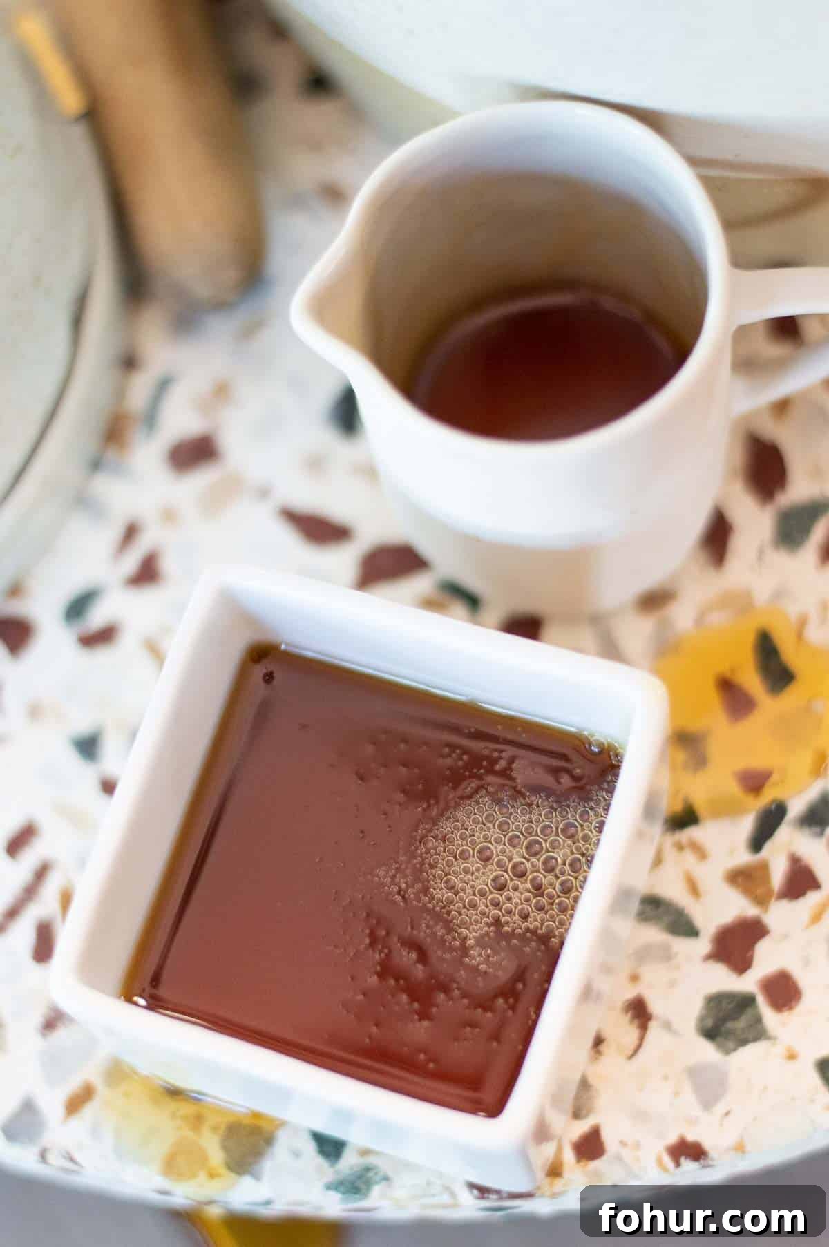 Maple syrup in bowl and cup