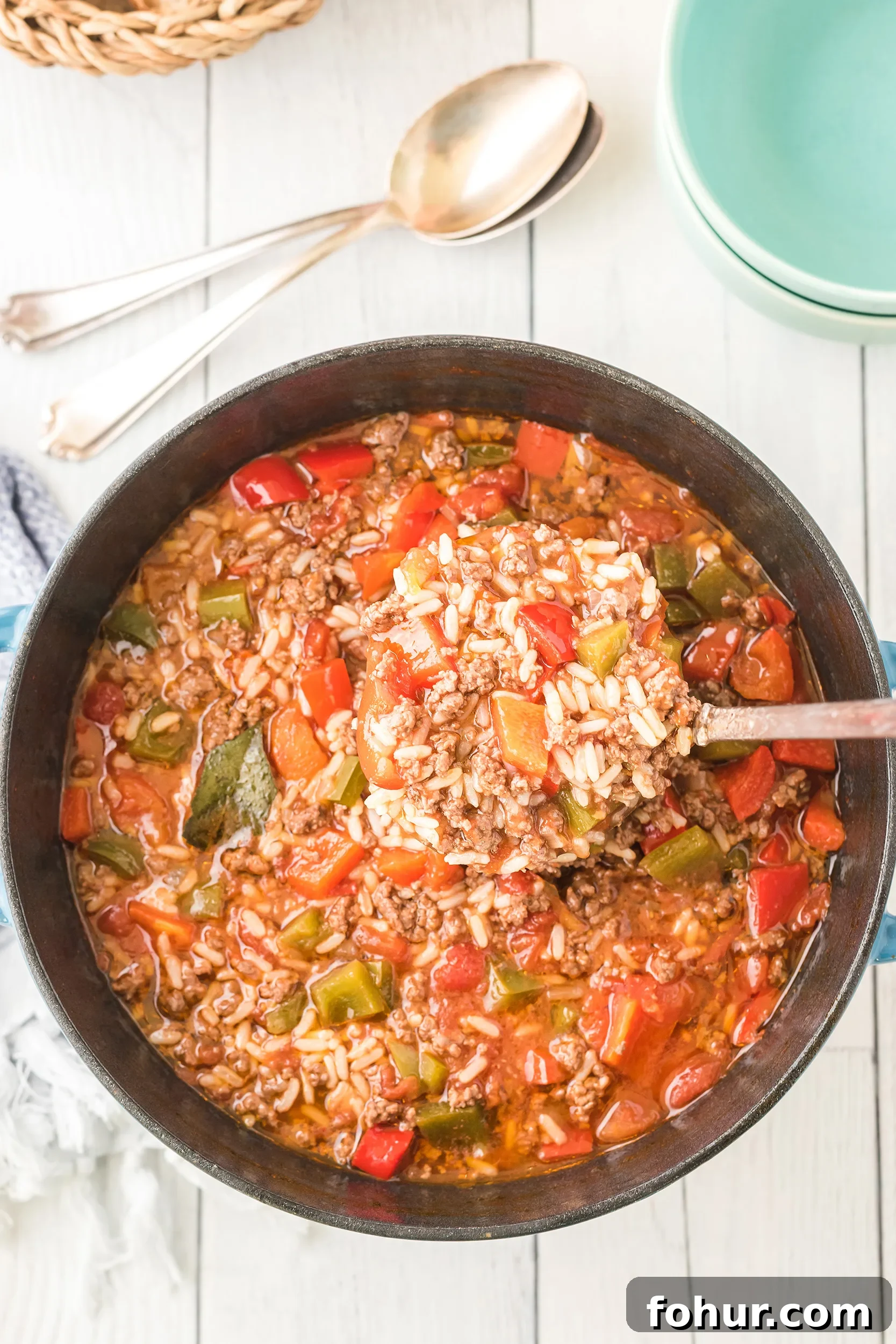 Stuffed Pepper Soup Recipe That Warms the Soul 5 stuffed pepper soup being ladled out of the Dutch oven