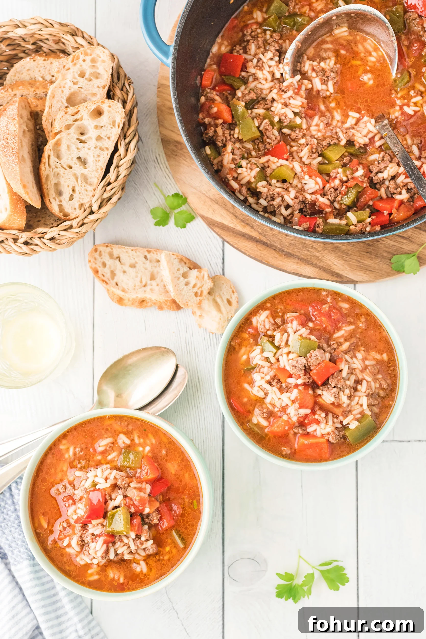 Stuffed Pepper Soup Recipe That Warms the Soul 8 two bowls of stuffed pepper soup with crusty bread on the side. The large soup pot is in the background