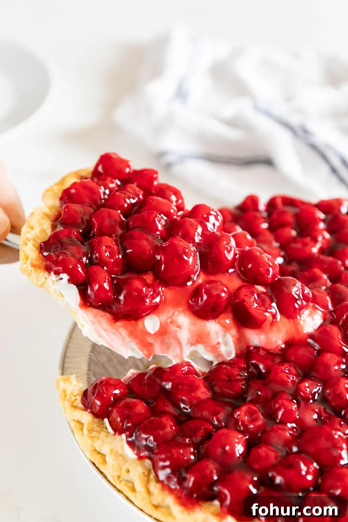 Cherry Cream Cheese Pie Recipe 2 A piece of cherry cheese pie being pulled up from the rest of the pie.