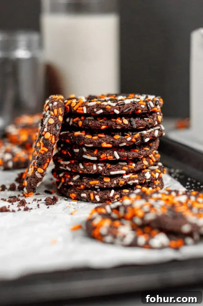 Spooky Gluten-Free Halloween Cookies with Dairy-Free Option 6 Dark black chocolate cookies covered in halloween inspired sprinkles.