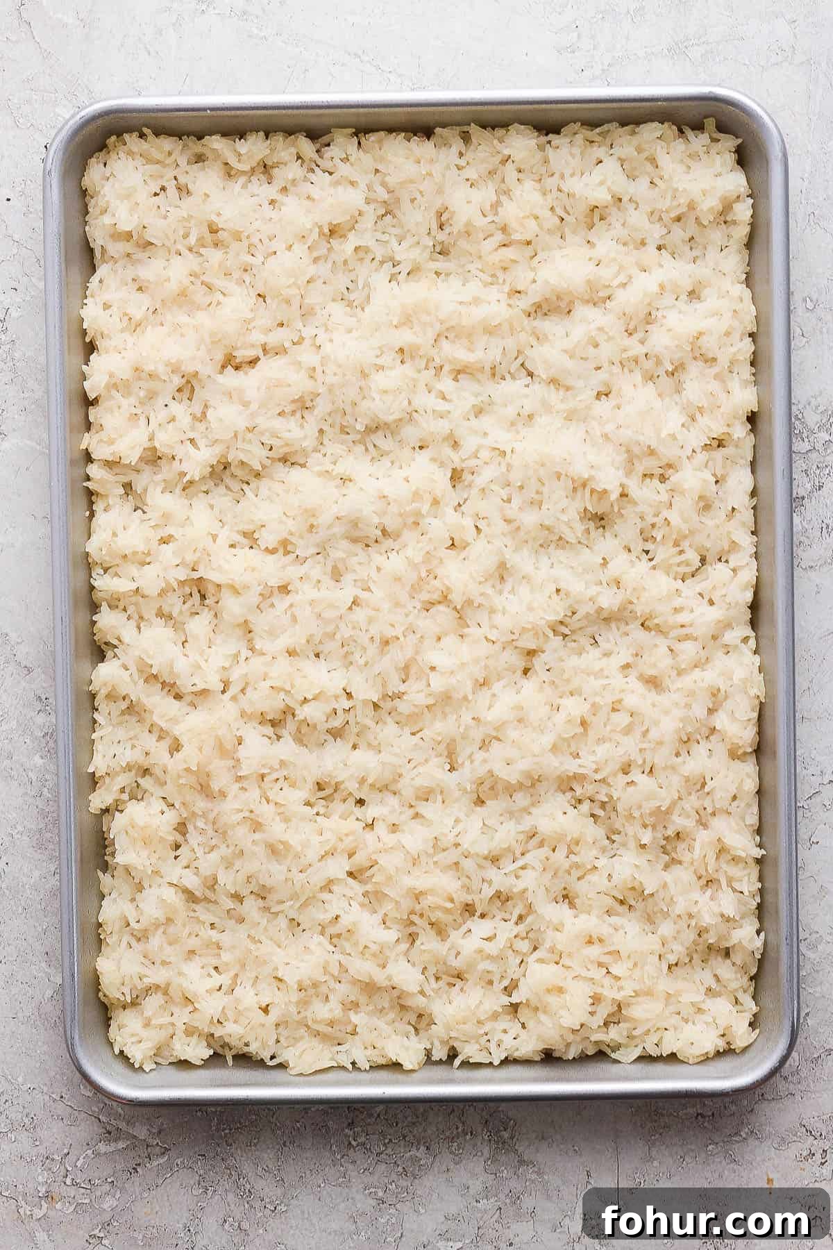 Sushi Bake Recipe: Creamy Baked Sushi Casserole 3 Rice in the baking pan before baking in the oven.