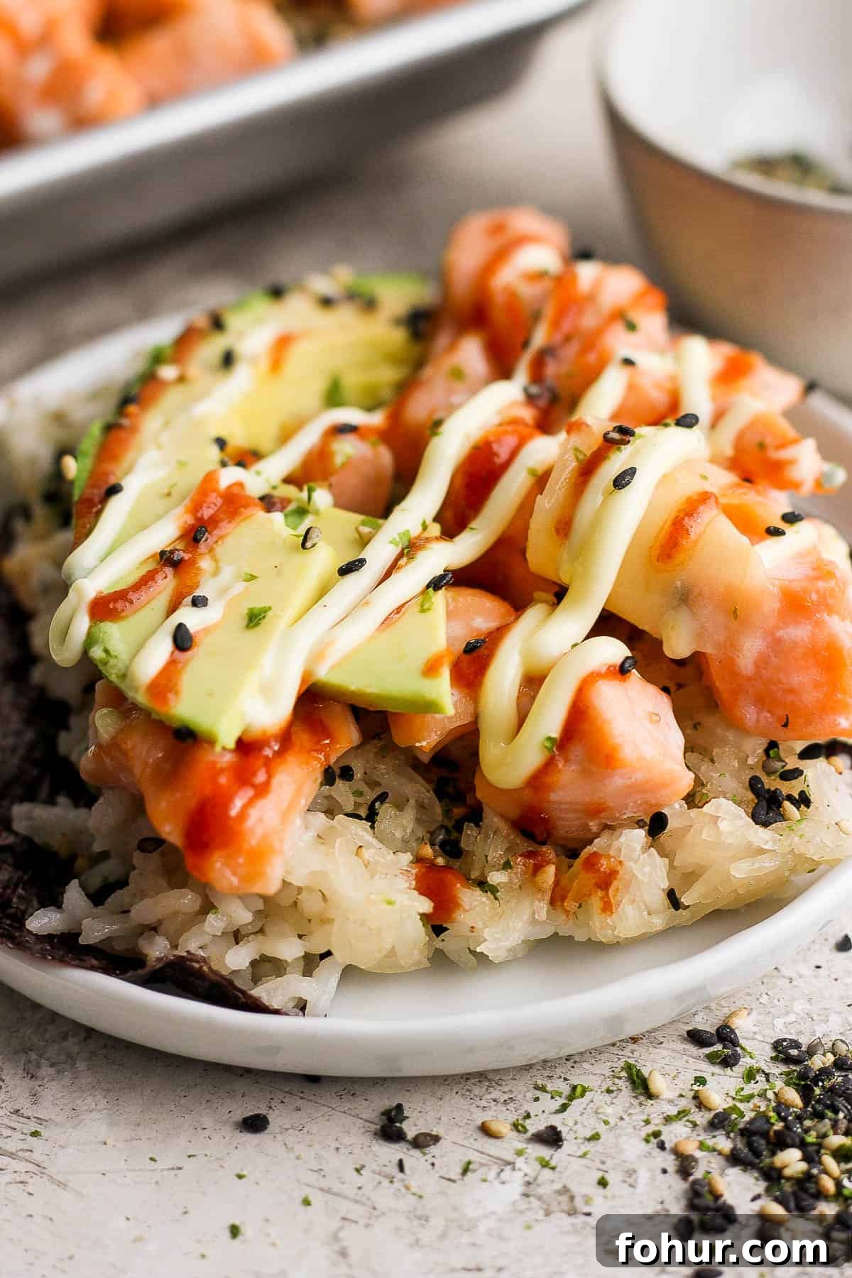 Sushi Bake Recipe: Creamy Baked Sushi Casserole 7 A piece of the sushi bake on a piece of seaweed on a plate.