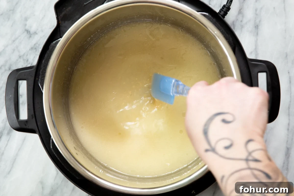 Instant Pot Vegan Cheese Sauce with Potatoes and Carrots 5 ingredients for vegan cheese sauce being mixed in an instant pot