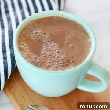 How to Make 108-Calorie Hot Cocoa (Video) 5 mug of cocoa on cutting board with napkin