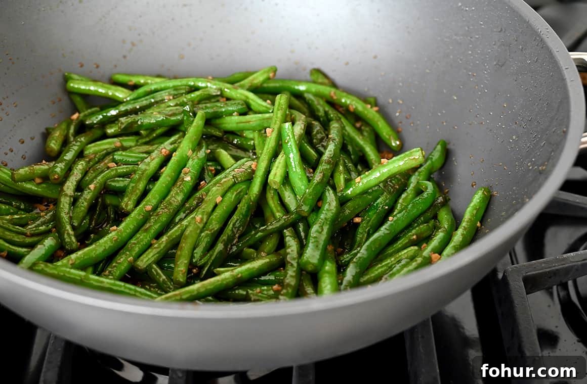 Stir-Fried Chinese Garlic Green Beans 4 A large skillet containing haricots