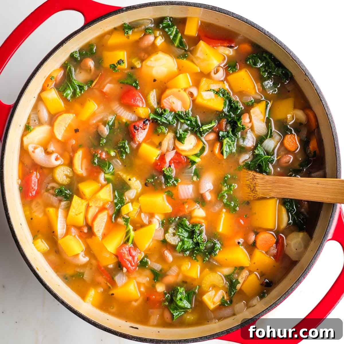 Vegan Fall Minestrone Soup with Roasted Autumn Vegetables 11 Minestrone with chunks of root veggies and butternut squash in broth in a dutch oven.